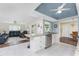 Open-concept kitchen featuring granite countertops, stainless steel appliances, tile floors, and eat-in bar at 2008 Pellam Blvd, Port Charlotte, FL 33948