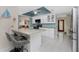 Bright kitchen features granite counters, white cabinets, and an adjacent bar area with stylish seating at 2008 Pellam Blvd, Port Charlotte, FL 33948