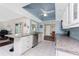 Bright, updated kitchen with white cabinets, granite counters, stainless steel appliances, and tiled flooring at 2008 Pellam Blvd, Port Charlotte, FL 33948