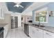Modern kitchen with stainless steel appliances, granite counters, updated cabinetry, and ample natural light at 2008 Pellam Blvd, Port Charlotte, FL 33948