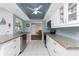 Modern kitchen featuring stainless steel appliances, granite countertops, white cabinetry, and a ceiling fan at 2008 Pellam Blvd, Port Charlotte, FL 33948