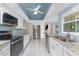 Updated kitchen with granite countertops, white cabinetry, stainless steel appliances, and recessed lighting at 2008 Pellam Blvd, Port Charlotte, FL 33948