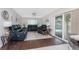 Cozy living room with dark leather furniture and sliding glass door to the pool at 2008 Pellam Blvd, Port Charlotte, FL 33948