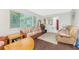 Cozy living room featuring hardwood floors, a large window, and comfortable seating arrangements at 2008 Pellam Blvd, Port Charlotte, FL 33948
