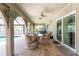 Outdoor patio with seating and view of a hot tub and backyard at 2008 Pellam Blvd, Port Charlotte, FL 33948