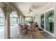 Inviting covered patio with seating and outdoor dining area, perfect for entertaining by the pool at 2008 Pellam Blvd, Port Charlotte, FL 33948
