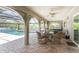 Covered patio featuring outdoor seating, ceiling fan, and view of pool and backyard at 2008 Pellam Blvd, Port Charlotte, FL 33948