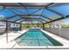 Screened-in pool area features a beautiful pool, brick floors, and ample space for outdoor relaxation and entertaining at 2008 Pellam Blvd, Port Charlotte, FL 33948