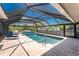 Screened-in pool area features a beautiful pool, brick floors, and ample space for outdoor relaxation and entertaining at 2008 Pellam Blvd, Port Charlotte, FL 33948