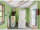 Functional laundry room includes stacked washer and dryer, and a water heater at 20167 Rutherford Ave, Port Charlotte, FL 33952