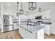 Bright kitchen featuring stainless steel appliances, granite countertops, and white cabinetry at 23120 Newcun Ave, Punta Gorda, FL 33980
