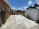 Wide driveway and backyard with bicycles and storage shed, great for outdoor recreation at 2328 Picnic St, Port Charlotte, FL 33952