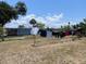 A view of the backyard featuring a clothesline, dry grass, and perimeter fence at 2328 Picnic St, Port Charlotte, FL 33952
