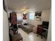 Small bedroom with a ceiling fan, posters and desk at 2328 Picnic St, Port Charlotte, FL 33952