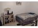 Bedroom with tile floors, a full bed and a wooden shelving unit at 2328 Picnic St, Port Charlotte, FL 33952