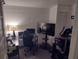 Bedroom with a large TV, desk, and exercise equipment for a home office and gym at 2328 Picnic St, Port Charlotte, FL 33952