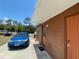 A blue Ford Focus is parked alongside the home's exterior with a hello doormat at 2328 Picnic St, Port Charlotte, FL 33952