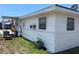 Back exterior of home with white vinyl siding and a small tomato garden at 2328 Picnic St, Port Charlotte, FL 33952