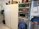 A pantry is shown, fully stocked with a microwave and other items at 2328 Picnic St, Port Charlotte, FL 33952