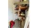 A view of a small storage room with shelving holding a variety of items at 2328 Picnic St, Port Charlotte, FL 33952