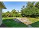 A spacious, green backyard featuring lush landscaping, plants, and ample space for outdoor activities at 2381 Sheila Ln, North Port, FL 34286