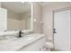 Bathroom with granite countertop, white cabinets, and a white door to the backyard at 2381 Sheila Ln, North Port, FL 34286