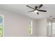 Bright bedroom with modern ceiling fan, fresh paint, and natural light from large windows at 2381 Sheila Ln, North Port, FL 34286