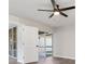 Bedroom features fan, wood-look flooring, and sliding glass doors to the screened patio at 2381 Sheila Ln, North Port, FL 34286
