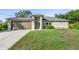 Charming single-story home with a well-maintained lawn and two-car garage in a lovely neighborhood at 2381 Sheila Ln, North Port, FL 34286
