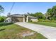 Well-maintained single-story home with a paved driveway and a lovely lawn and attached two car garage at 2381 Sheila Ln, North Port, FL 34286