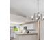 Modern kitchen featuring white cabinets, stainless steel appliances, granite counters, and stylish chandelier at 2381 Sheila Ln, North Port, FL 34286