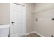 Bright laundry room with white cabinetry, shelving, and a door leading to the rest of the home at 2381 Sheila Ln, North Port, FL 34286