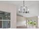 Spacious living room with high ceilings, fan, wood-look floors and natural light from large windows at 2381 Sheila Ln, North Port, FL 34286