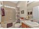 Cozy bathroom with floral accents, a shower-tub combo, and wood vanity at 24371 Folkstone Ave, Punta Gorda, FL 33980