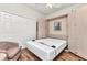 Guest bedroom features a Murphy bed, closet, laminate floors, and chair; space-saving design at 24371 Folkstone Ave, Punta Gorda, FL 33980