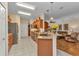 Spacious kitchen with granite countertops, stainless steel appliances, wood cabinets, and an open layout to the living area at 24371 Folkstone Ave, Punta Gorda, FL 33980