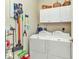Convenient laundry room equipped with a washer, dryer, and ample storage at 24371 Folkstone Ave, Punta Gorda, FL 33980