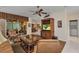 Inviting living room showcases wood flooring, a ceiling fan, and views of the outdoor area at 24371 Folkstone Ave, Punta Gorda, FL 33980