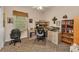 Comfortable office featuring built-in desk, shelving, large window, and seating at 24371 Folkstone Ave, Punta Gorda, FL 33980