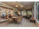 Spacious screened-in patio furnished with wicker seating and ceiling fans, perfect for outdoor dining at 24371 Folkstone Ave, Punta Gorda, FL 33980