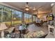 Large screened lanai featuring comfortable seating arrangements and views of the landscaped backyard at 24371 Folkstone Ave, Punta Gorda, FL 33980