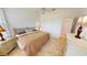 Comfortable bedroom features neutral tones, tiled floor, ceiling fan, and spacious closets at 26089 Seminole Lakes Blvd, Punta Gorda, FL 33955