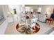 Bright breakfast nook with a glass-top table, white chairs, and a view into the open-concept living space at 26089 Seminole Lakes Blvd, Punta Gorda, FL 33955