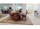 Formal dining room with rich wood table and chairs, decorative rug, and mirrored wall that enhances the spacious feel at 26089 Seminole Lakes Blvd, Punta Gorda, FL 33955