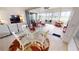Enclosed Florida room featuring tile floors, modern furniture, bright natural light, and picturesque outdoor views at 26089 Seminole Lakes Blvd, Punta Gorda, FL 33955