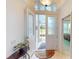 Bright foyer with tile flooring and doorway views of the front yard and a cozy bedroom at 26089 Seminole Lakes Blvd, Punta Gorda, FL 33955