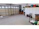 Spacious garage provides ample storage with cabinets and shelving, with a clean floor and bright lighting at 26089 Seminole Lakes Blvd, Punta Gorda, FL 33955
