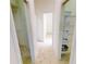 Bright hallway featuring tiled floors, white walls, and access to multiple rooms in the home at 26089 Seminole Lakes Blvd, Punta Gorda, FL 33955