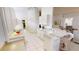 Open kitchen with tiled floors, white cabinets and adjacent living area, providing a functional design at 26089 Seminole Lakes Blvd, Punta Gorda, FL 33955