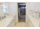Practical laundry room with a utility sink, ample storage cabinets, and easy access to the garage at 26089 Seminole Lakes Blvd, Punta Gorda, FL 33955